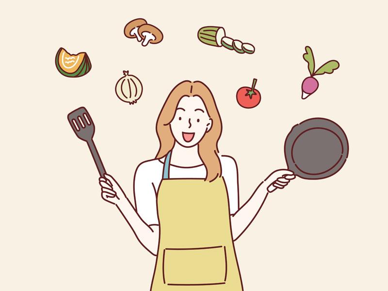 エプロン姿でフライパンとフライ返しを持つ女性と食材のイラスト